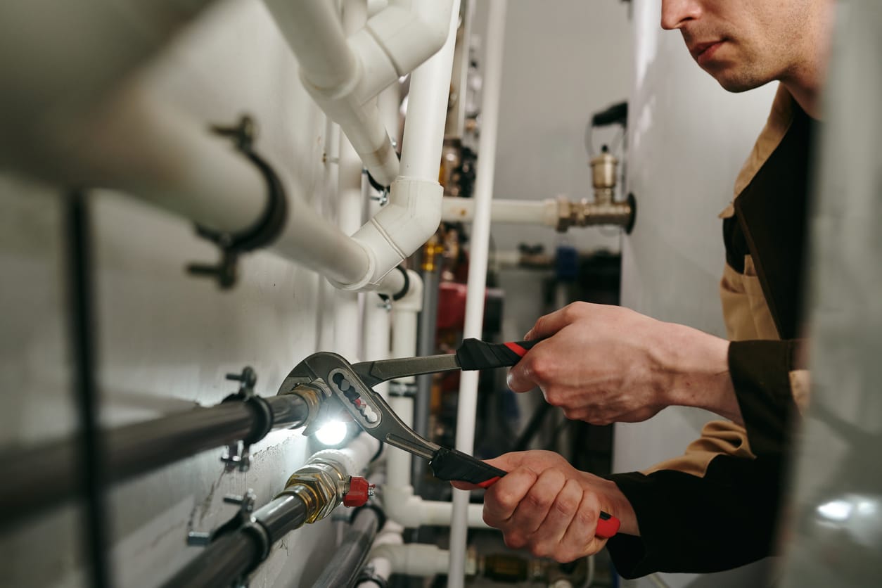 Plumbers maintaining commercial plumbing pipes in Calhoun