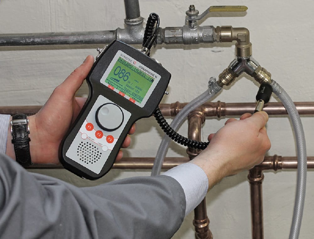 Plumber testing pipes with electronic leak detection equipment in Calhoun