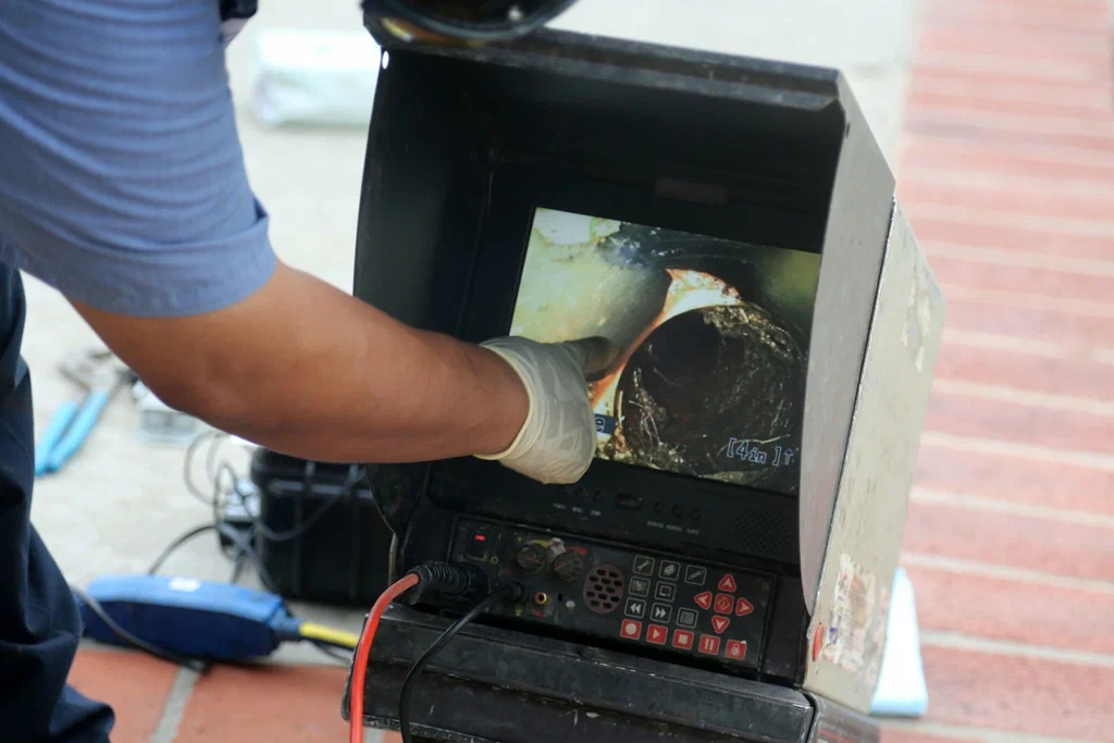 Technician viewing a drain inspection camera in Calhoun