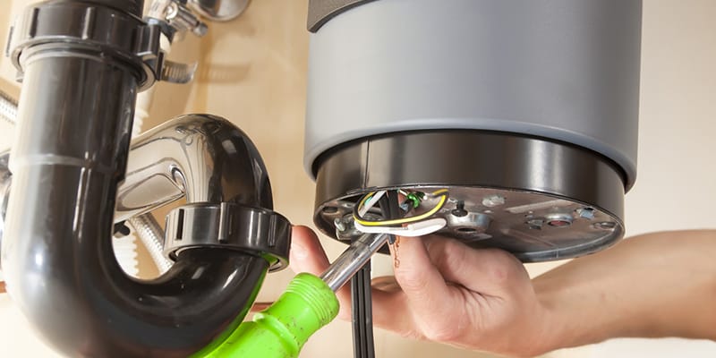 Technician repairing the heating element of a water heater in Calhoun