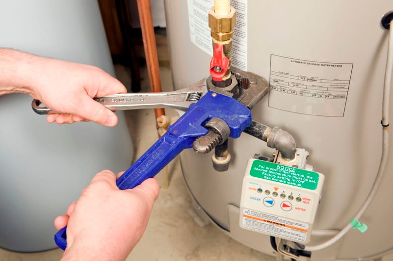 Plumber repairing a water heater valve in Calhoun